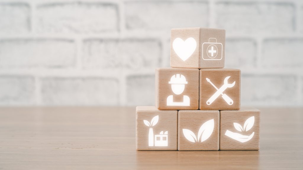 Health safety environment HSE education industry Concept, Man hand holding wooden cube block with Health safety environment icon with copy space.